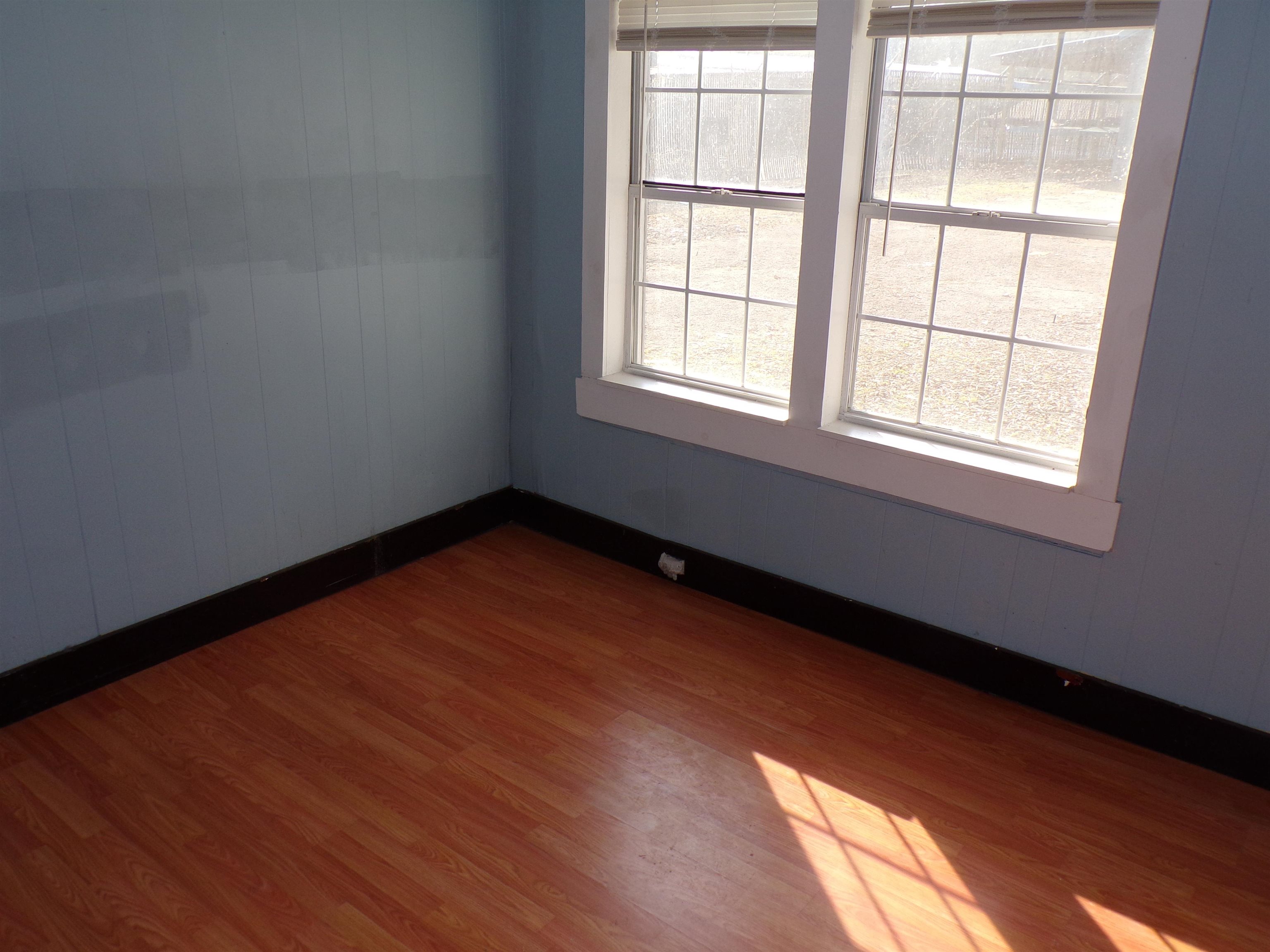5950 Highway 57 Counce, TN 38326 - Photo 13 of 23 Empty room with dark wood-style floors and wooden walls
