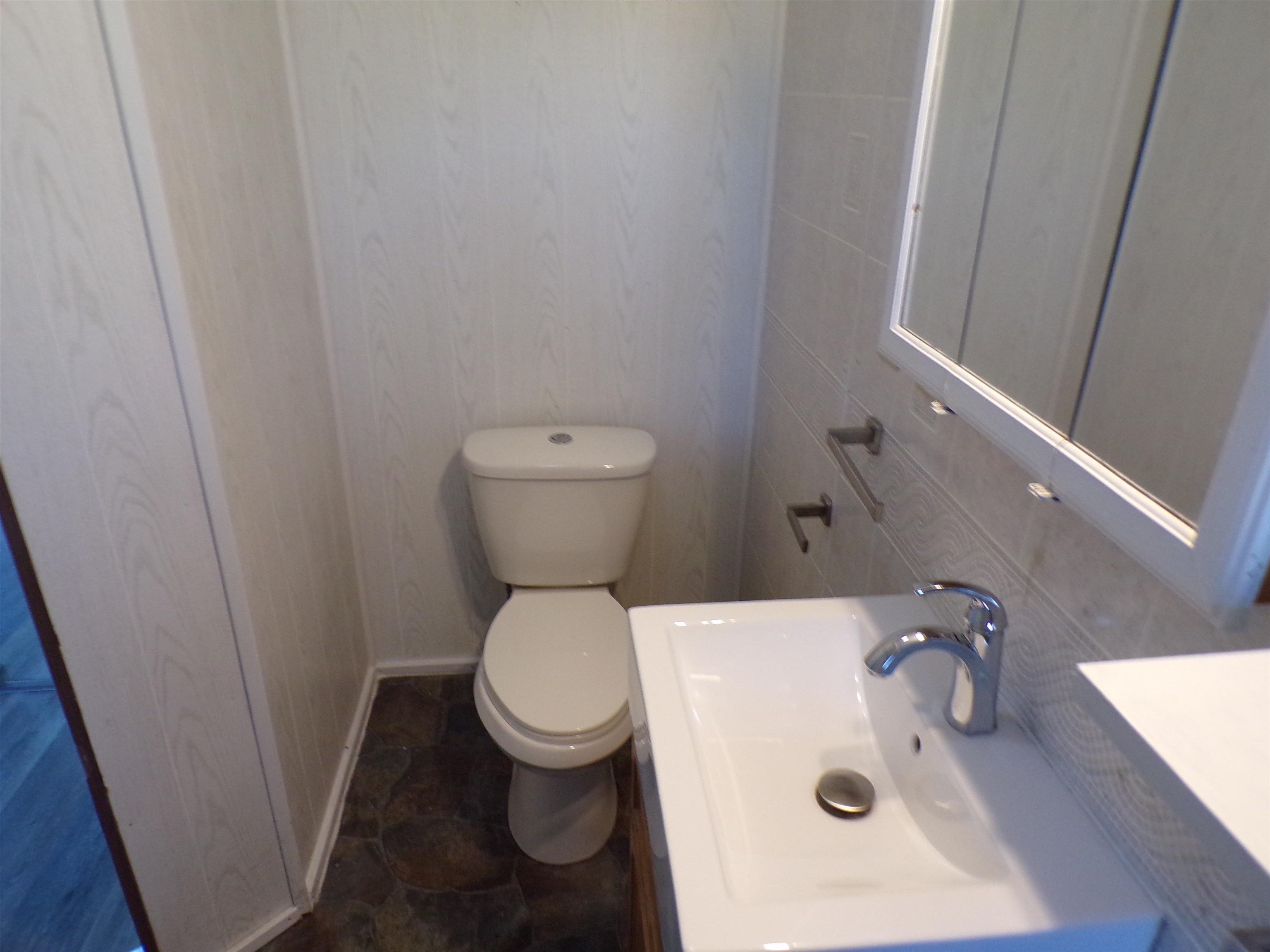 5950 Highway 57 Counce, TN 38326 - Photo 14 of 23 Half bath with vanity and dark stone finish flooring
