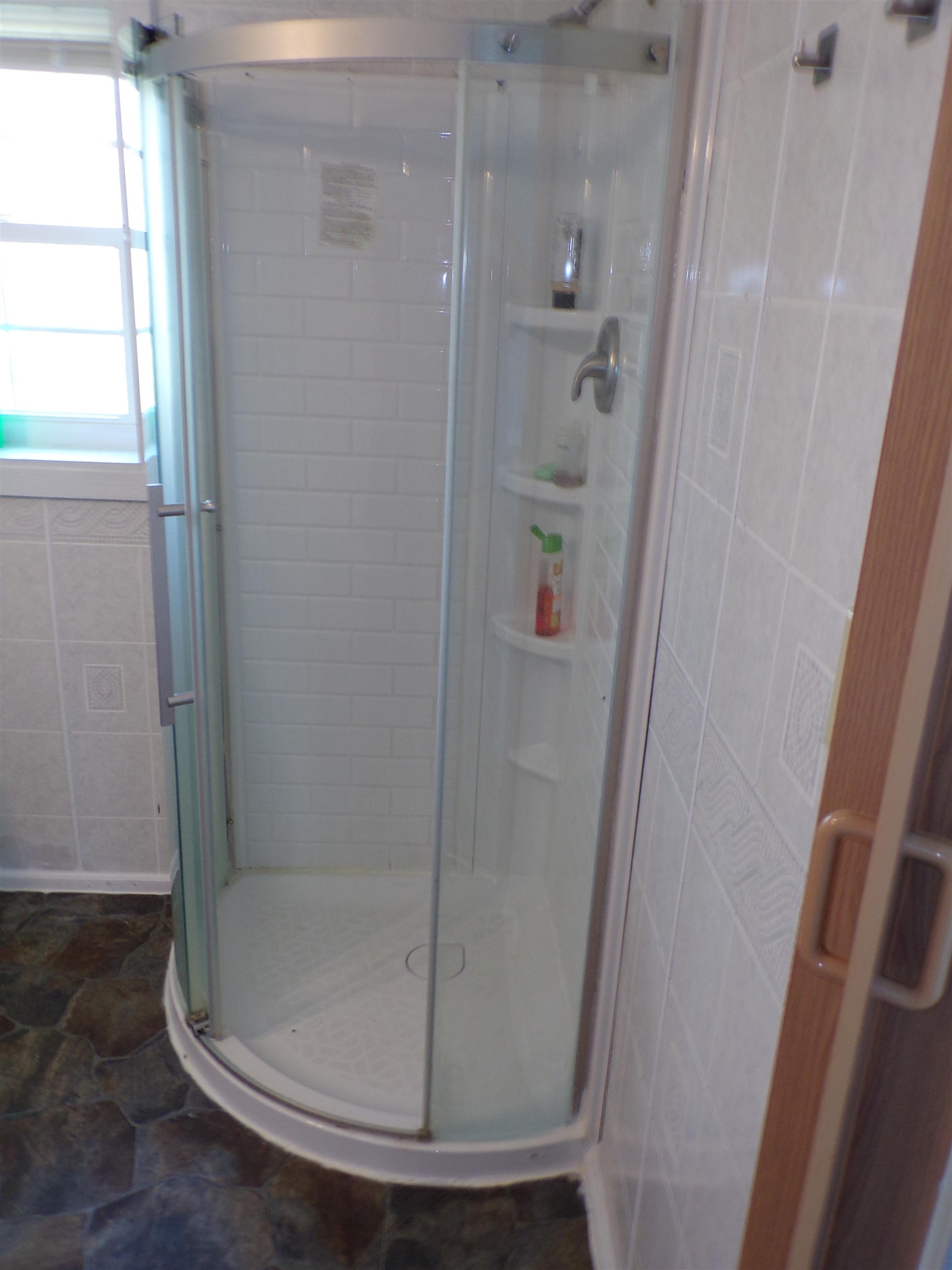 5950 Highway 57 Counce, TN 38326 - Photo 15 of 23 Bathroom featuring a shower stall, dark stone finish floors, and tile walls