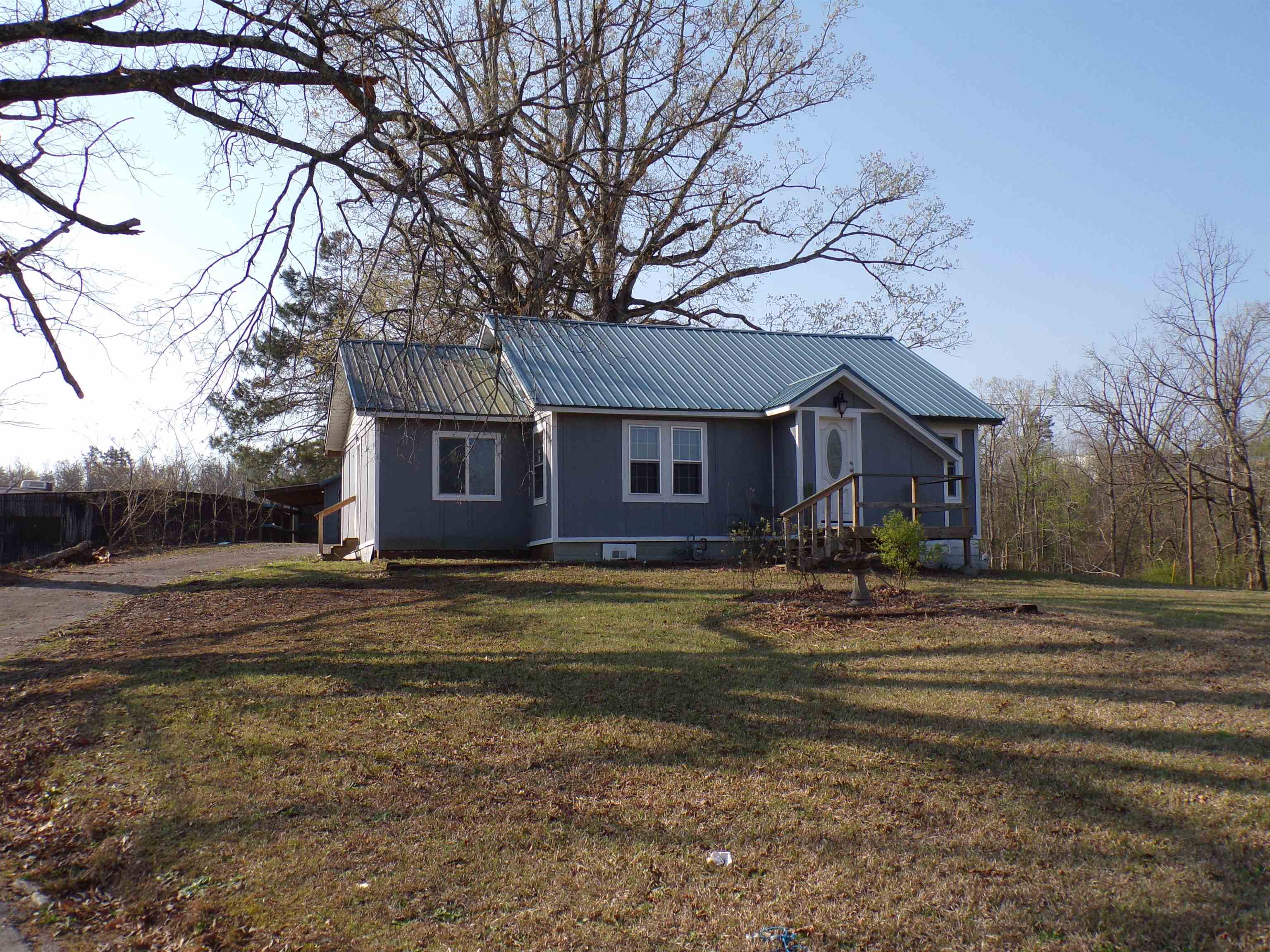 5950 Highway 57 Counce, TN 38326 - Photo 3 of 23 View of front facade with a metal roof and a front lawn