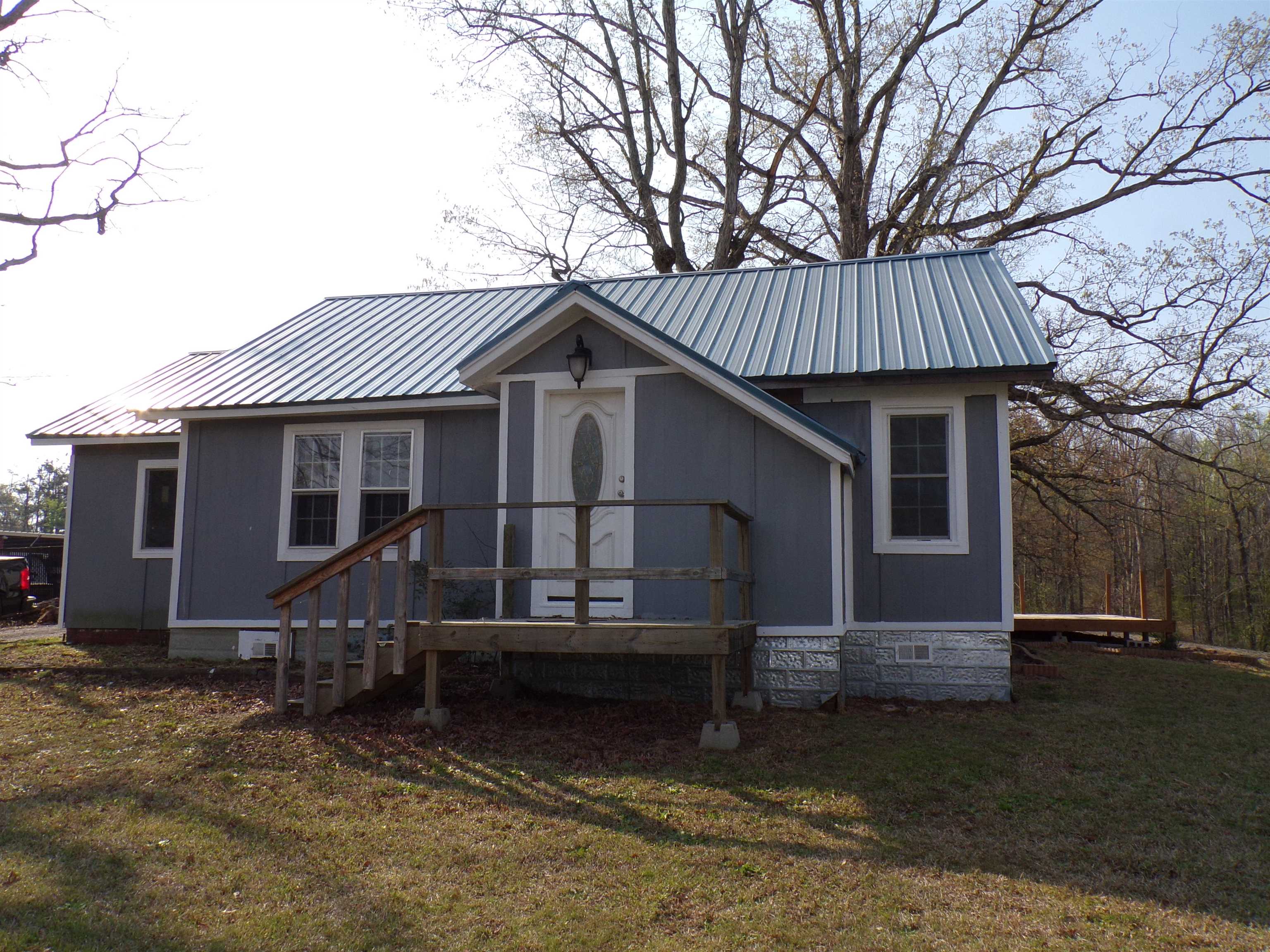 5950 Highway 57 Counce, TN 38326 - Photo 4 of 23 View of front of property featuring a front lawn and a metal roof