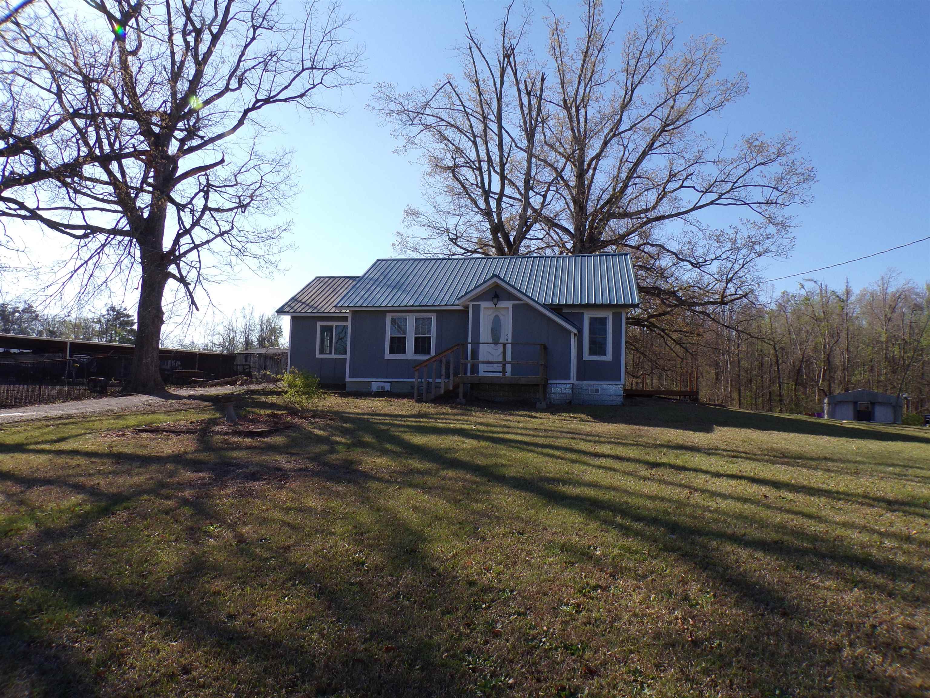 5950 Highway 57 Counce, TN 38326 - Photo 5 of 23 View of front of house featuring crawl space, a metal roof, and a front lawn