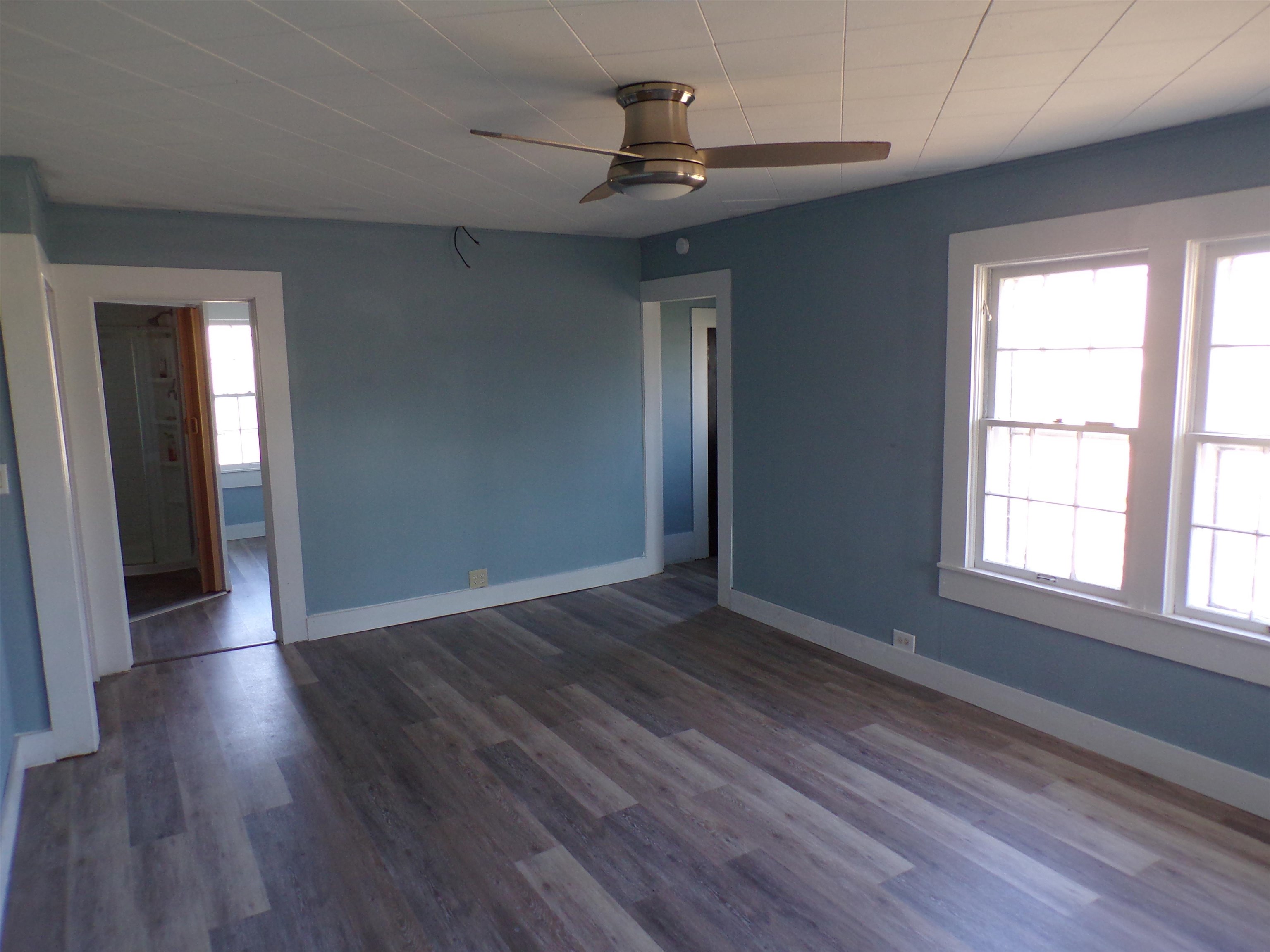 5950 Highway 57 Counce, TN 38326 - Photo 6 of 23 Unfurnished room with ceiling fan and dark wood-style floors