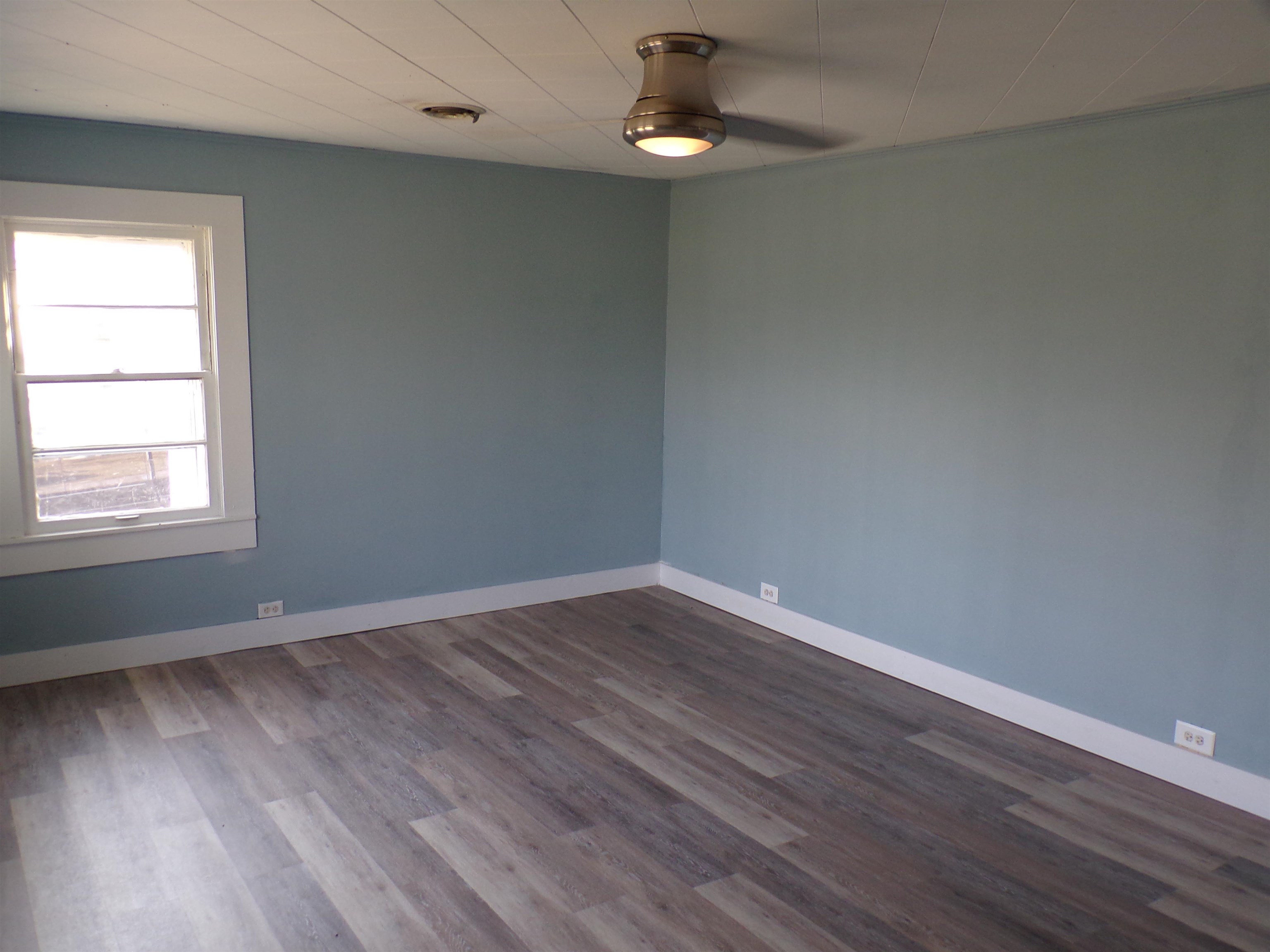 5950 Highway 57 Counce, TN 38326 - Photo 7 of 23 Empty room featuring dark wood-style flooring and a ceiling fan