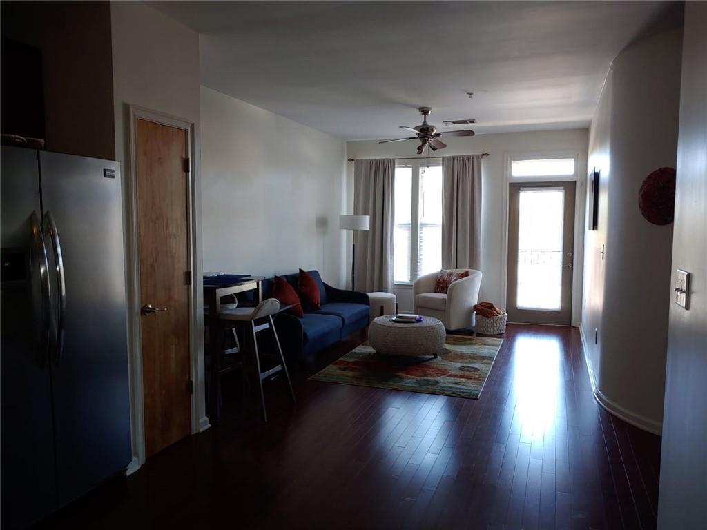 898 Oak Street Southwest, Unit 3405 Atlanta, GA 30310 - Photo 4 of 9 a living room with furniture and a chandelier