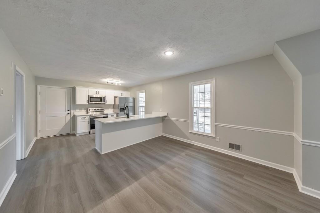 2870 Horseshoe Bend Road Southwest Marietta, GA 30064 - Photo 14 of 37 a large white kitchen with wooden floors and kitchen view