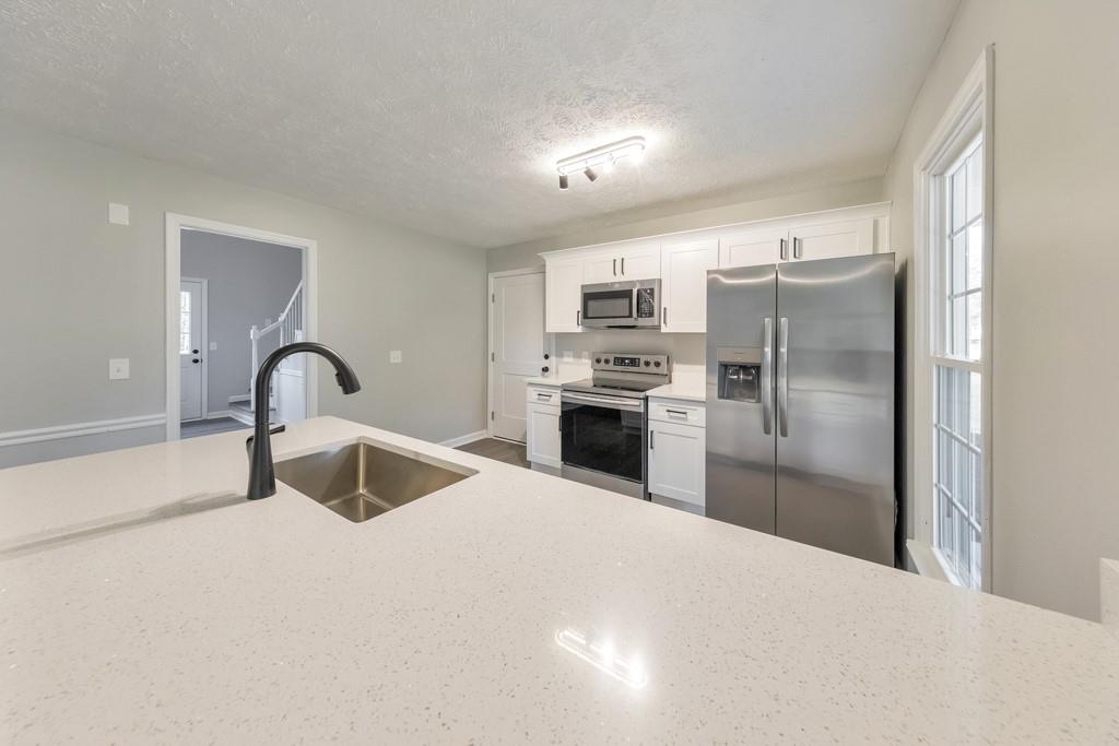 2870 Horseshoe Bend Road Southwest Marietta, GA 30064 - Photo 15 of 37 a kitchen with granite countertop a refrigerator and a sink