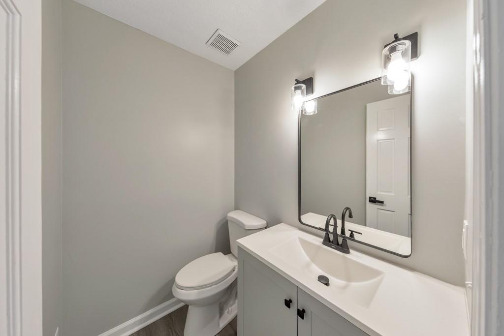 2870 Horseshoe Bend Road Southwest Marietta, GA 30064 - Photo 17 of 37 a bathroom with a sink toilet and a mirror