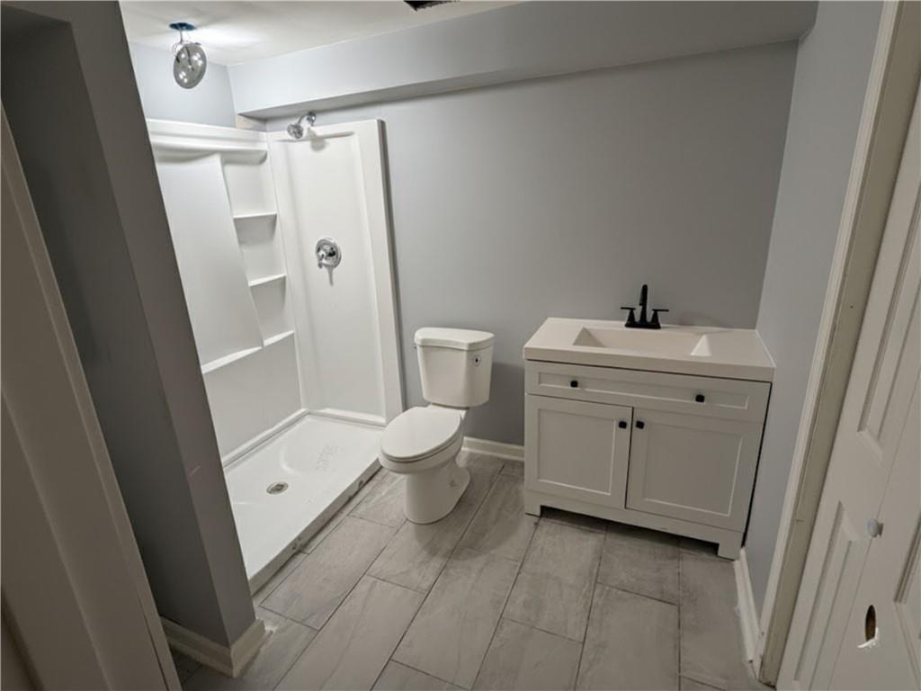 2870 Horseshoe Bend Road Southwest Marietta, GA 30064 - Photo 21 of 21 a bathroom with a sink a toilet and shower