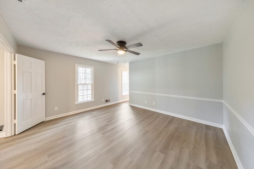 2870 Horseshoe Bend Road Southwest Marietta, GA 30064 - Photo 22 of 37 an empty room with wooden floor and windows
