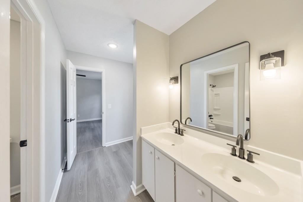 2870 Horseshoe Bend Road Southwest Marietta, GA 30064 - Photo 24 of 37 a bathroom with a double vanity sink and mirror
