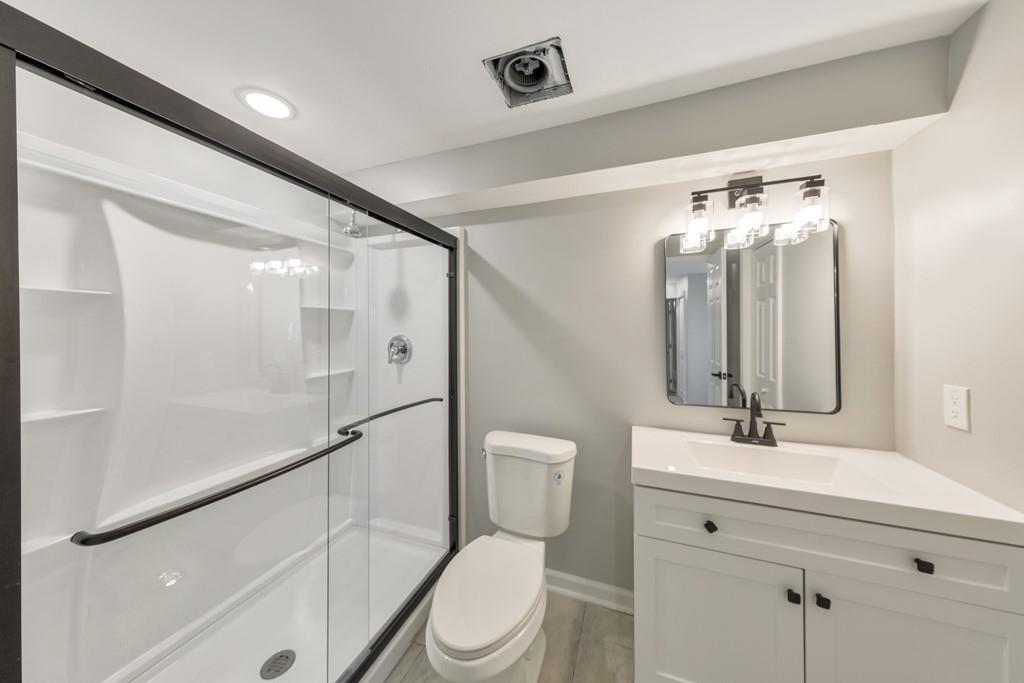 2870 Horseshoe Bend Road Southwest Marietta, GA 30064 - Photo 27 of 37 a bathroom with a toilet a sink and mirror