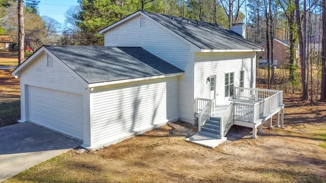 a view of a house with backyard and sitting area