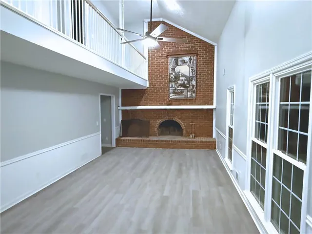 an empty room with windows dryer and fireplace