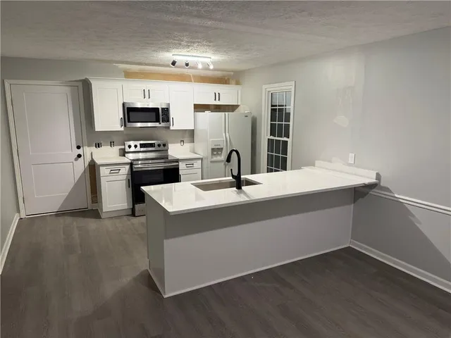 a kitchen with stainless steel appliances a sink and stove