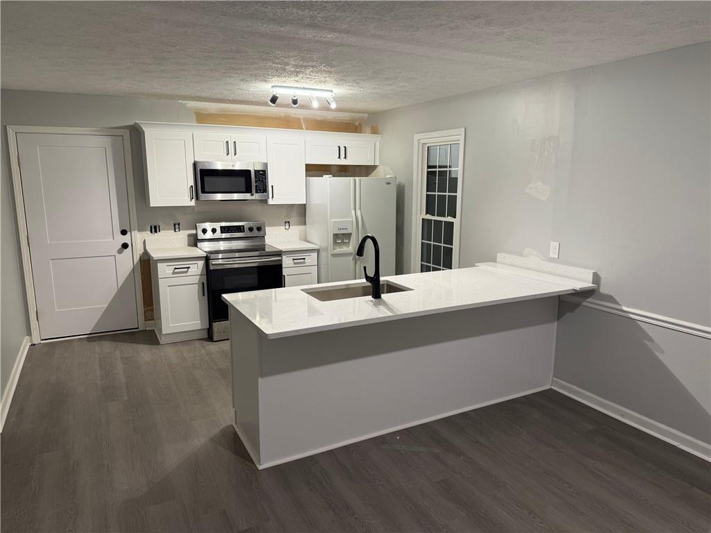 2870 Horseshoe Bend Road Southwest Marietta, GA 30064 - Photo 7 of 21 a kitchen with stainless steel appliances a sink and stove
