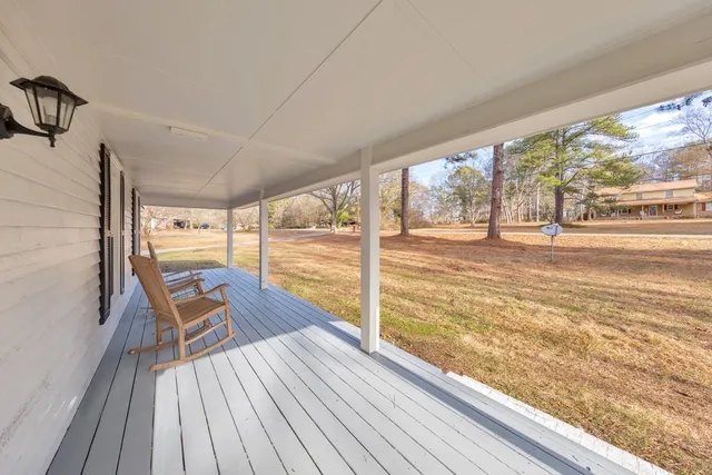 a view of a balcony with mountain view and wooden floor