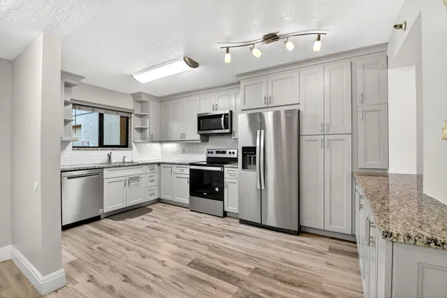a kitchen with a refrigerator sink and microwave