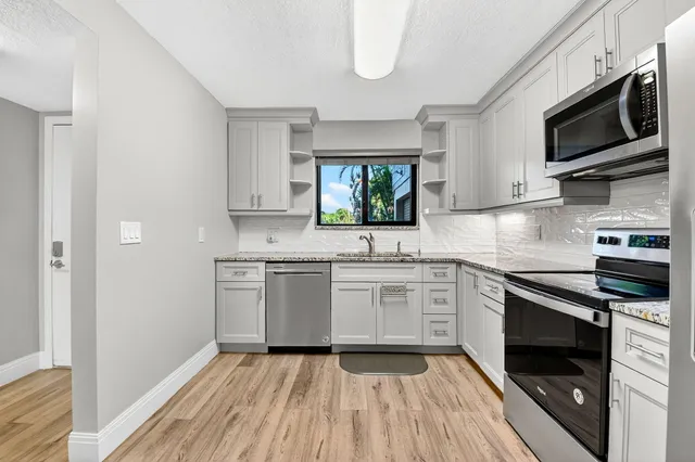 a kitchen with a sink stove and microwave