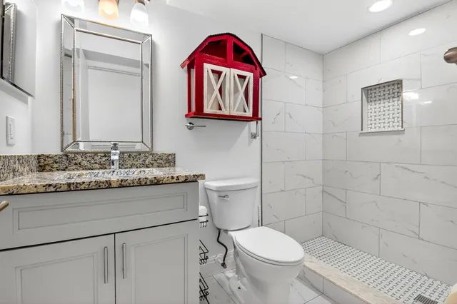 a bathroom with a toilet sink and mirror