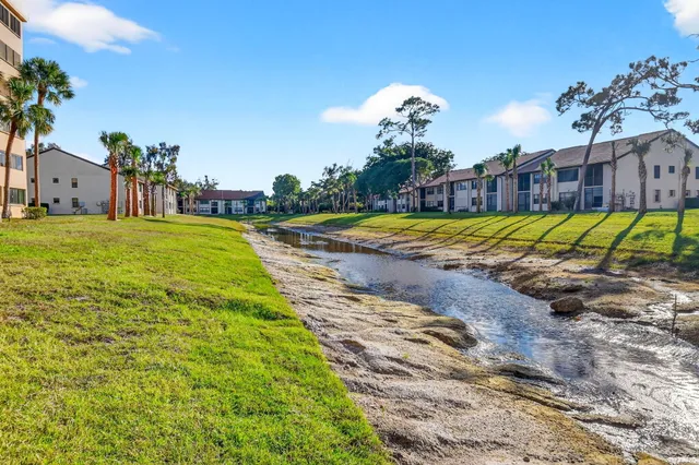 a view of a house with a yard and pathway