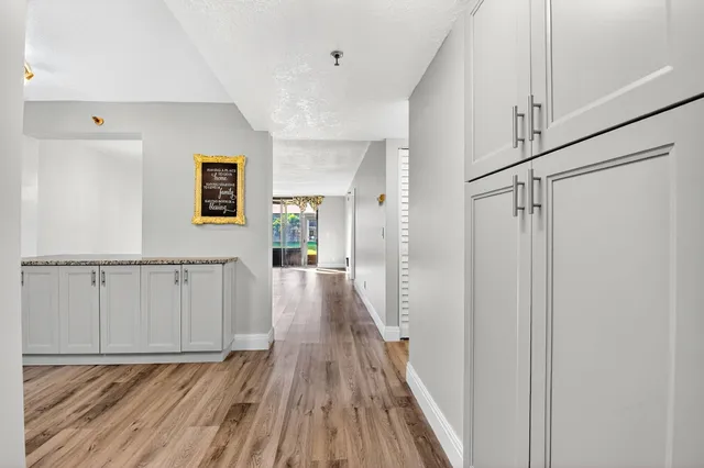 a view of a hallway with wooden floor and staircase