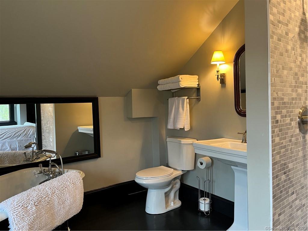 17 Kirby Road Washington, CT 06793 - Photo 17 of 20 a bathroom with a toilet mirror vanity and a sink