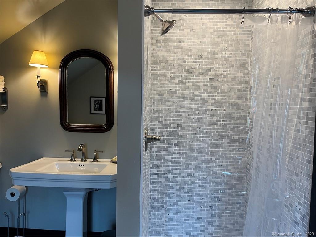 17 Kirby Road Washington, CT 06793 - Photo 18 of 20 a bathroom with a sink a mirror and shower
