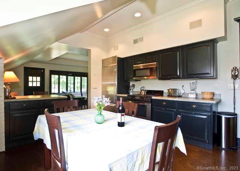 17 Kirby Road Washington, CT 06793 - Photo 2 of 20 a kitchen with stainless steel appliances kitchen island granite countertop a sink a stove a dining table and chairs