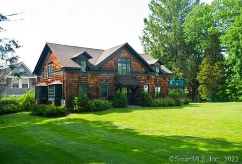 a front view of a house with yard and green space
