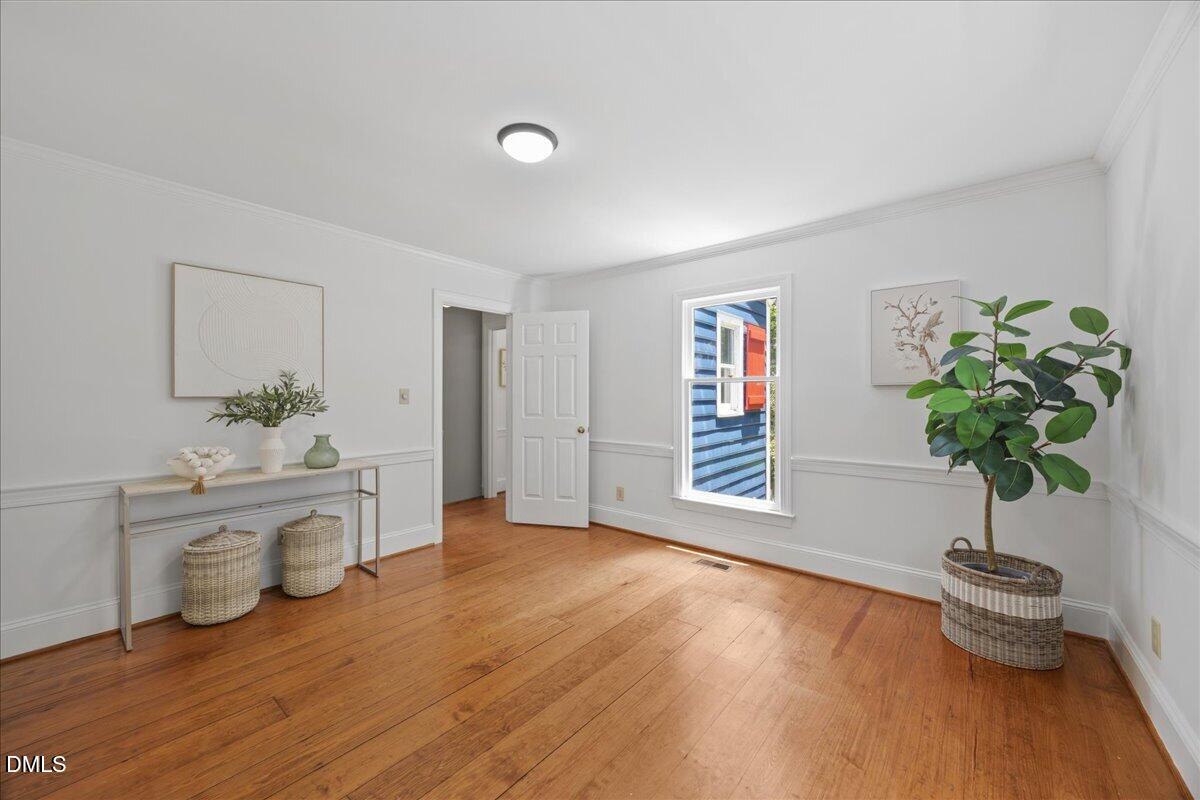 6516 Bakersfield Drive Raleigh, NC 27606 - Photo 25 of 59 a living room with furniture and a potted plant