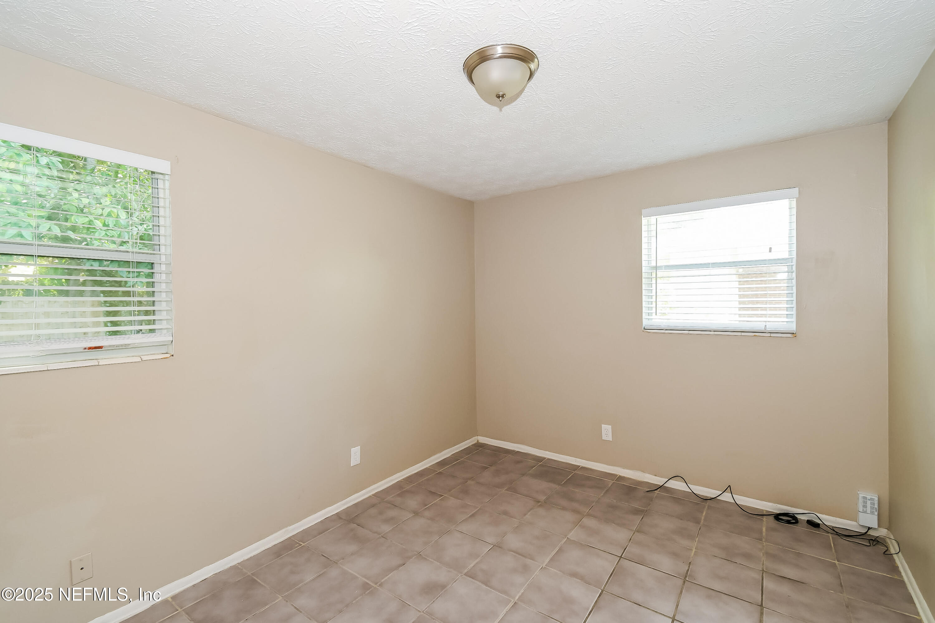 6430 Lucente Drive Jacksonville, FL 32210 - Photo 11 of 15 an empty room with windows