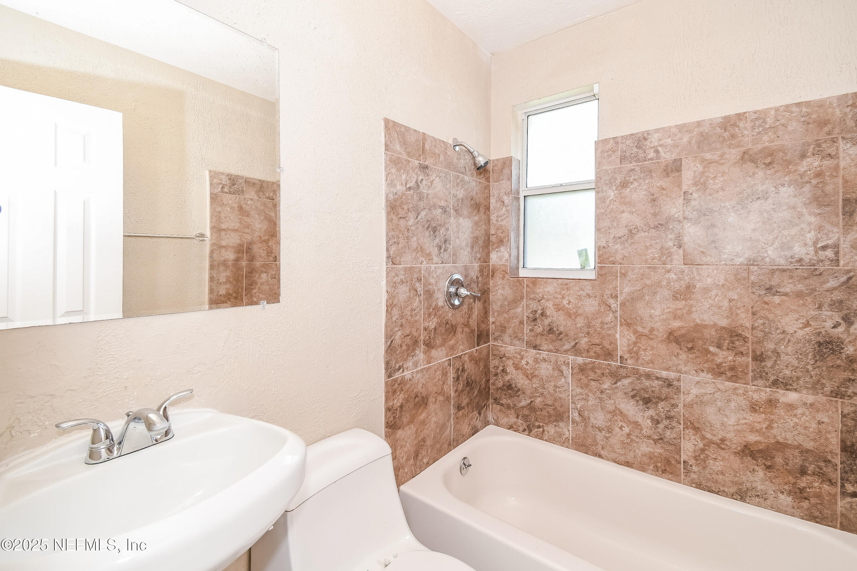 6430 Lucente Drive Jacksonville, FL 32210 - Photo 14 of 15 a bathroom with a bathtub and shower