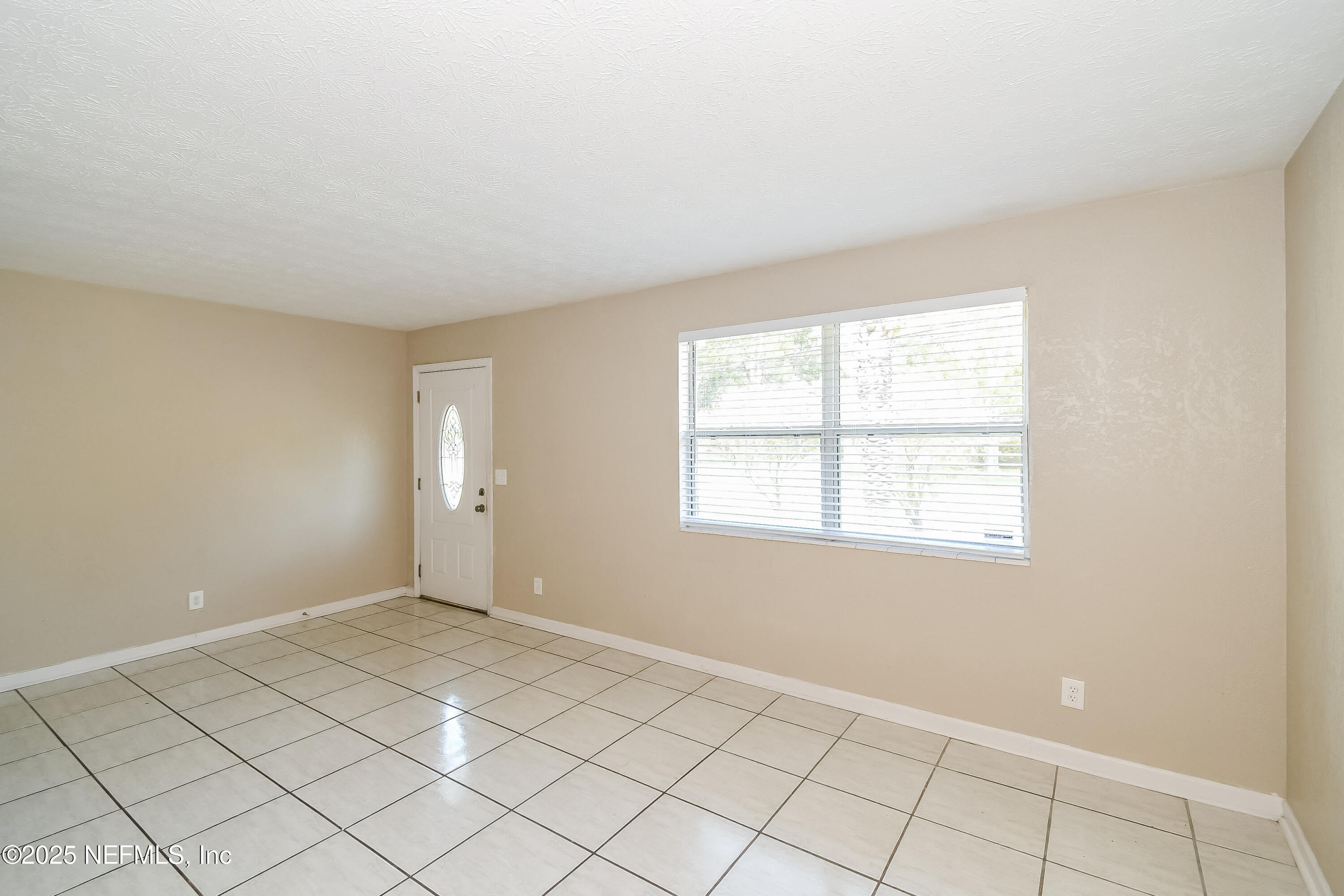 6430 Lucente Drive Jacksonville, FL 32210 - Photo 2 of 15 a view of an empty room and window