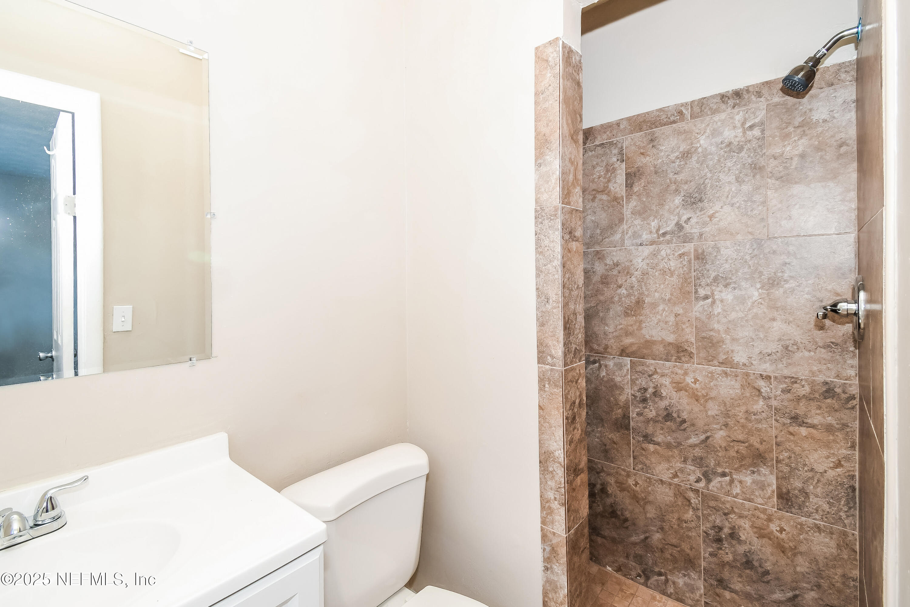 6430 Lucente Drive Jacksonville, FL 32210 - Photo 10 of 15 a bathroom with a toilet and a shower