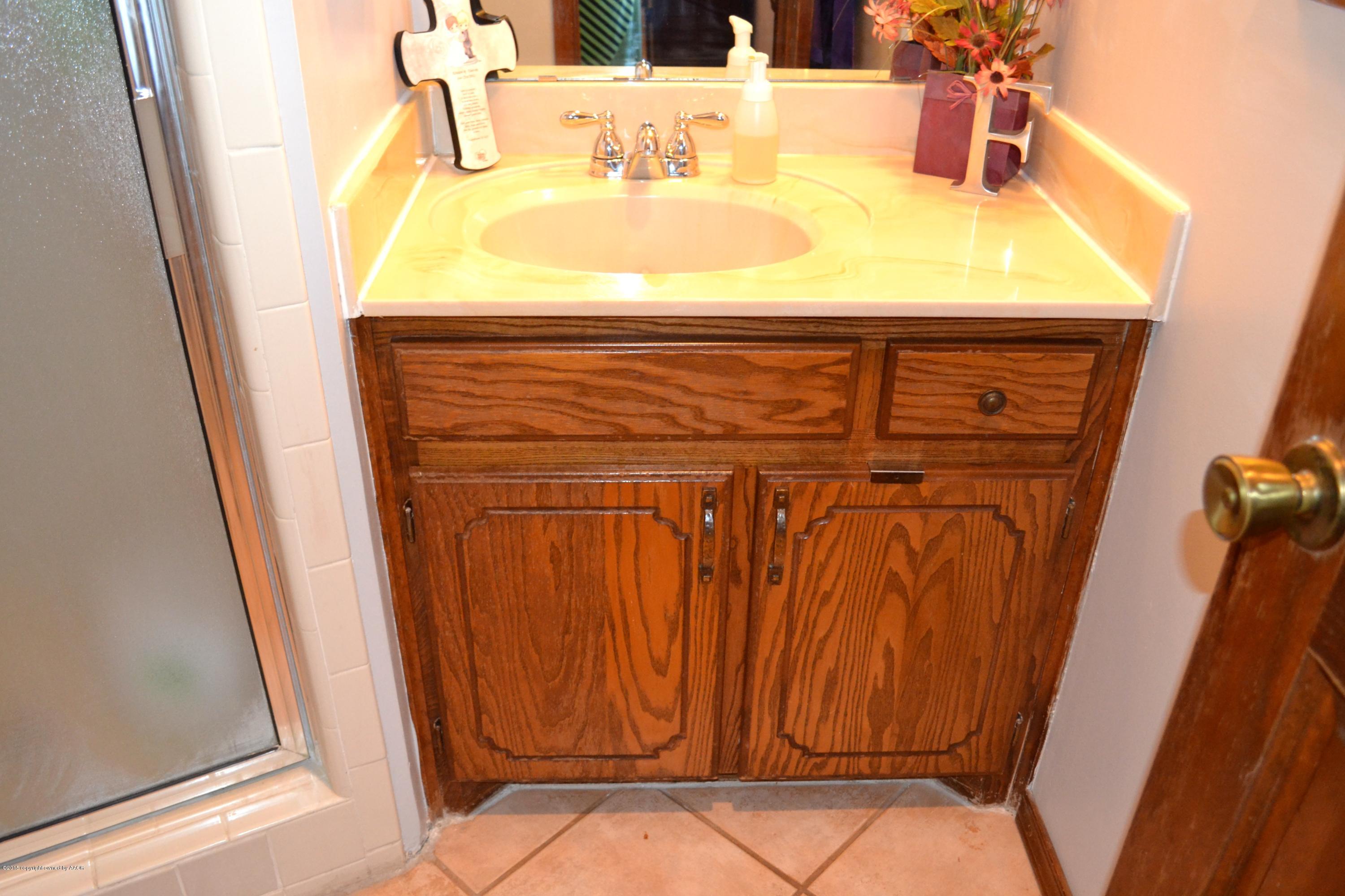 8305 Ranier Drive Amarillo, TX 79110 - Photo 46 of 54 a bathroom with a sink and a mirror