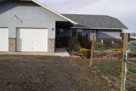 14809 Douglas Road Yakima, WA 98908 - Photo 1 of 6 a front view of a house with garden