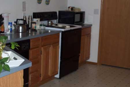 14809 Douglas Road Yakima, WA 98908 - Photo 5 of 6 a kitchen with stainless steel appliances granite countertop a sink a stove and a refrigerator