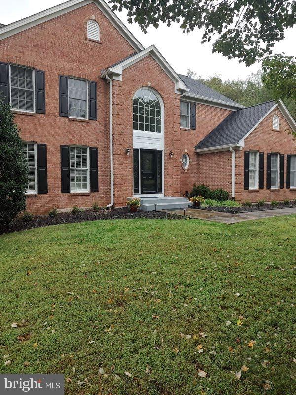6529 Garden Grove Way Gaithersburg, MD 20882 - Photo 1 of 14 a front view of a house with a yard and garage
