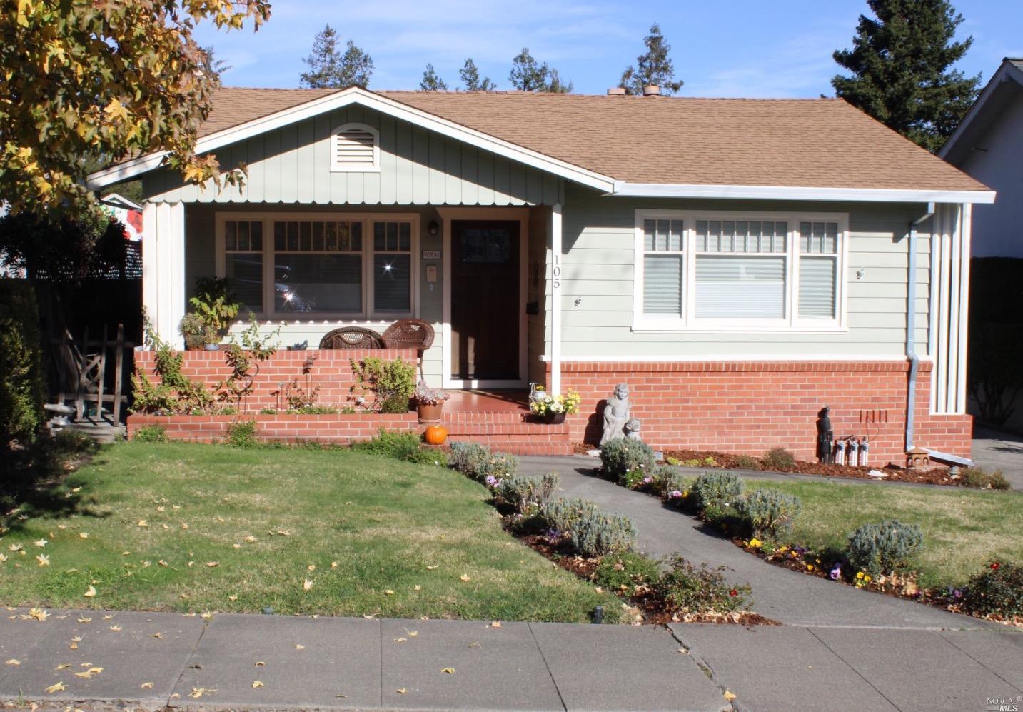 a front view of a house with a garden and porch