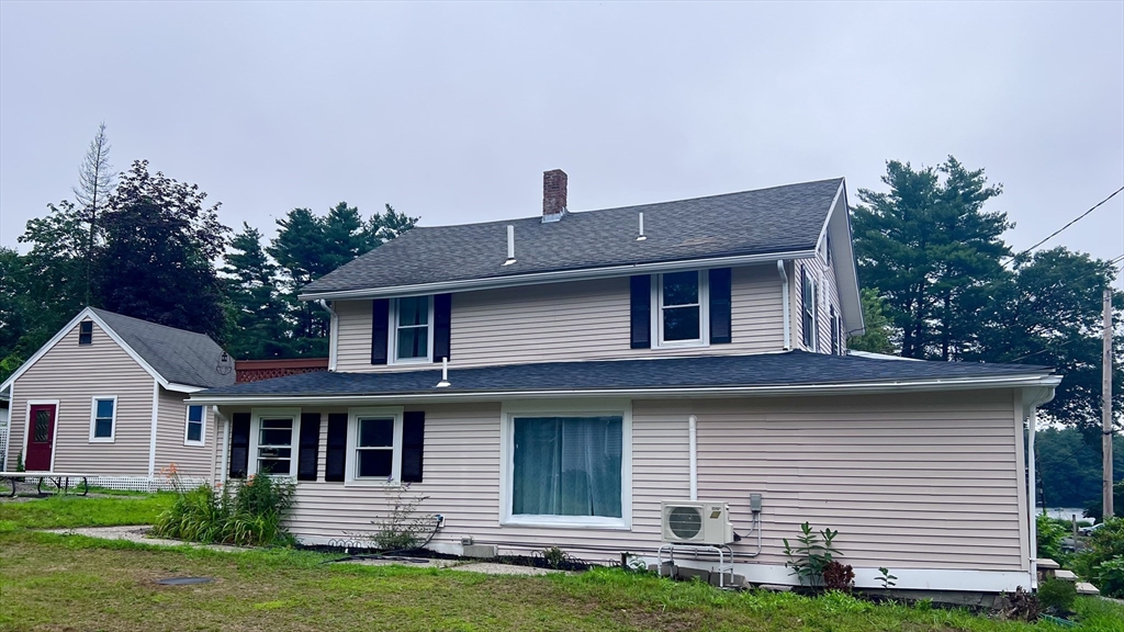 a front view of a house with a garden and yard