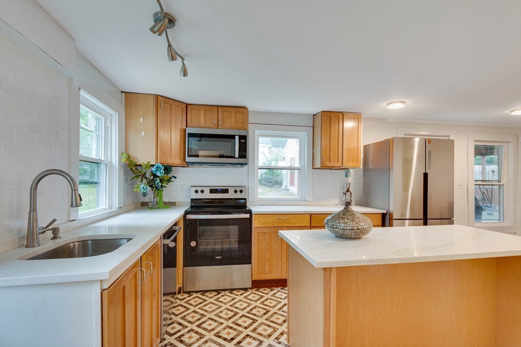 12 Temple Avenue Hudson, MA 01749 - Photo 8 of 32 a kitchen that has a sink and a stove in it
