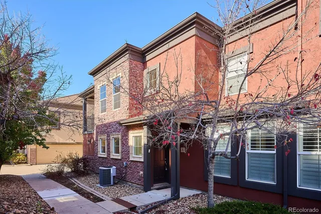 a front view of a building with a tree