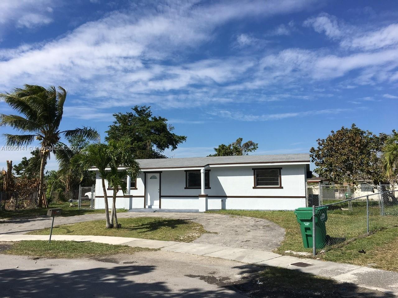 14535 Southwest 297th Terrace Homestead, FL 33033 - Photo 1 of 17 a front view of a house with a yard