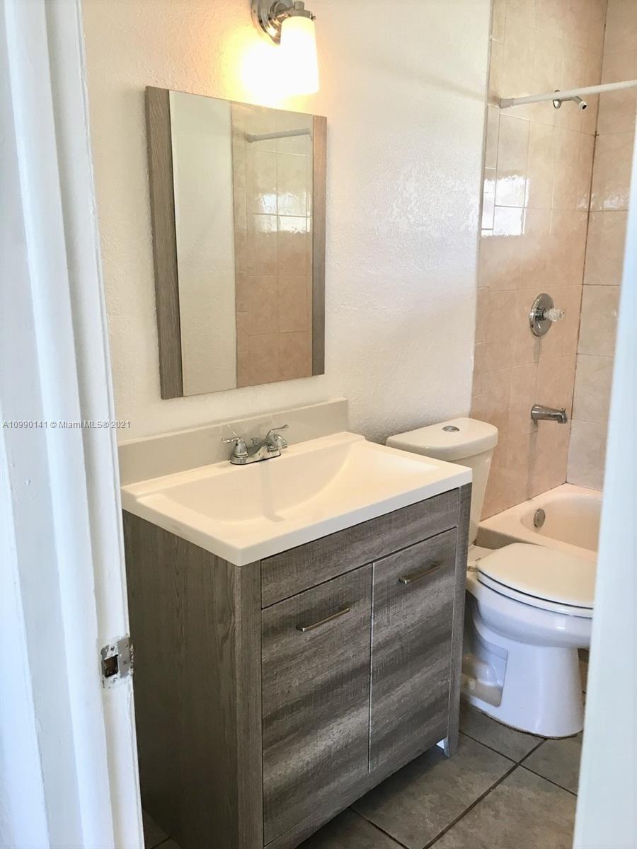 14535 Southwest 297th Terrace Homestead, FL 33033 - Photo 11 of 17 a bathroom with a sink toilet and shower