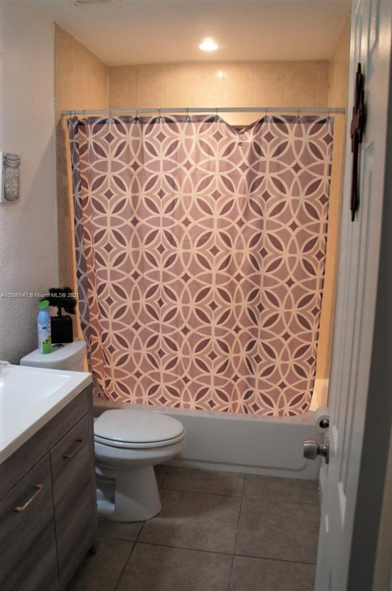 14535 Southwest 297th Terrace Homestead, FL 33033 - Photo 13 of 17 a bathroom with a toilet and a shower curtain