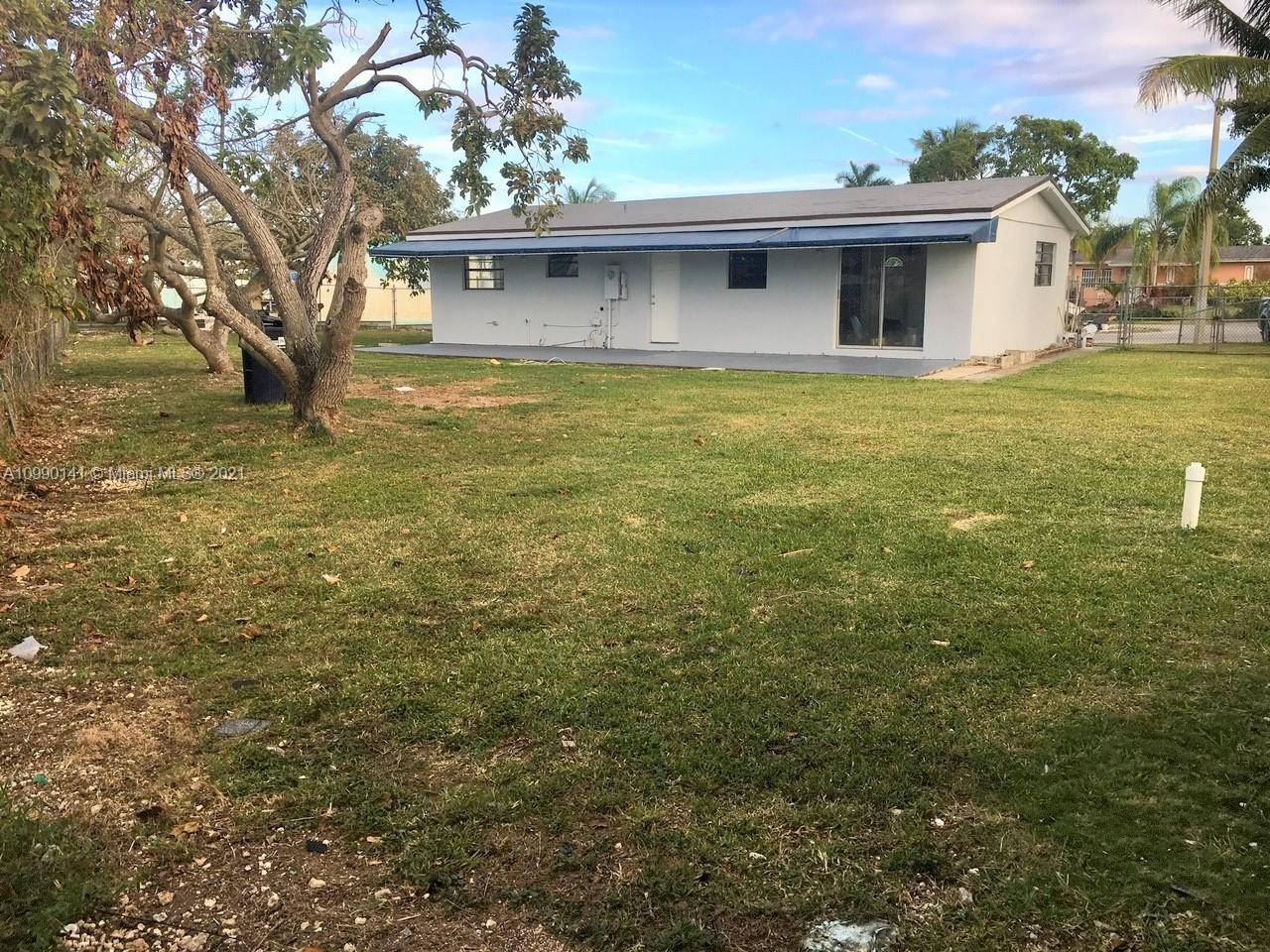 14535 Southwest 297th Terrace Homestead, FL 33033 - Photo 15 of 17 a view of a yard in front of a house with a large tree