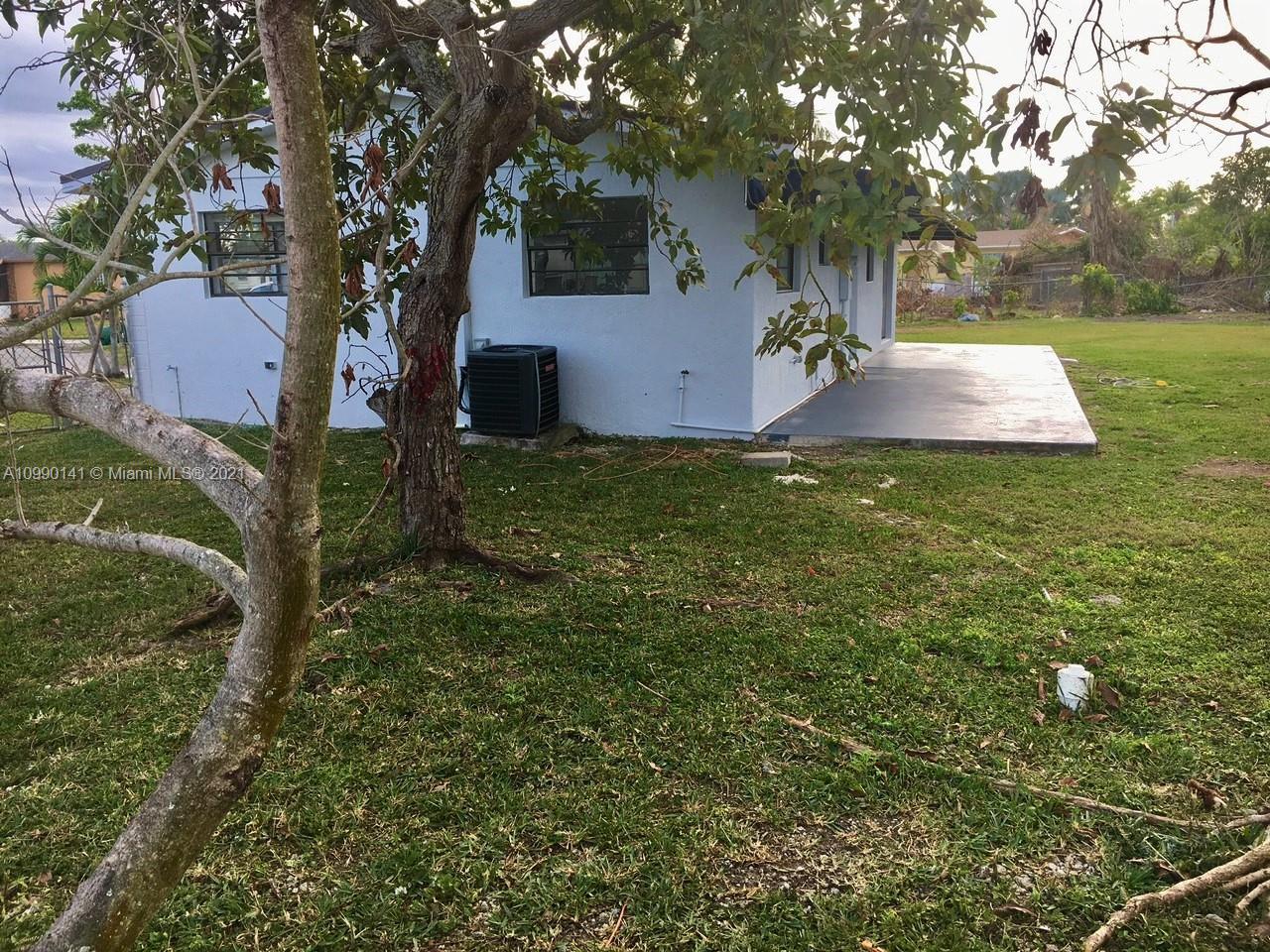 14535 Southwest 297th Terrace Homestead, FL 33033 - Photo 16 of 17 a backyard of a house with lots of green space