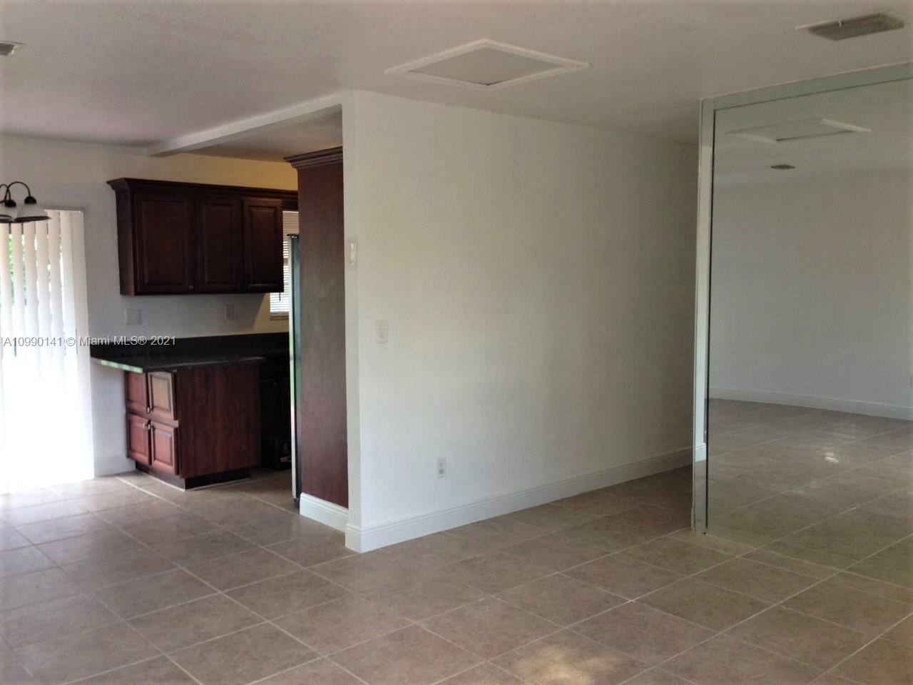 14535 Southwest 297th Terrace Homestead, FL 33033 - Photo 4 of 17 a view of an empty room with a kitchen