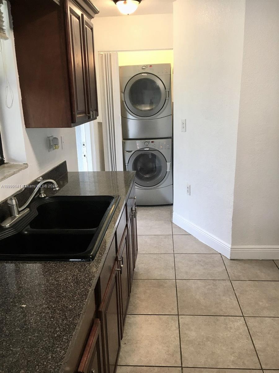 14535 Southwest 297th Terrace Homestead, FL 33033 - Photo 7 of 17 a kitchen with a sink a stove and a microwave